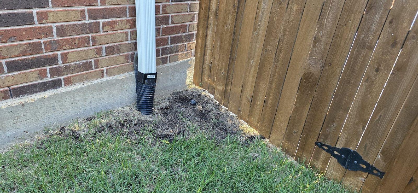 Downspout tied into an underground drain line away from the foundation