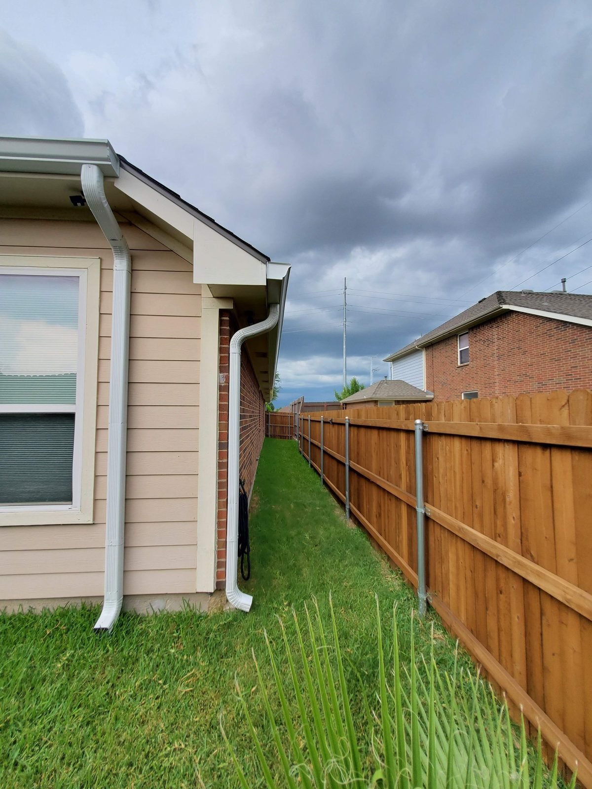 Downspouts on a Texas home before a storm