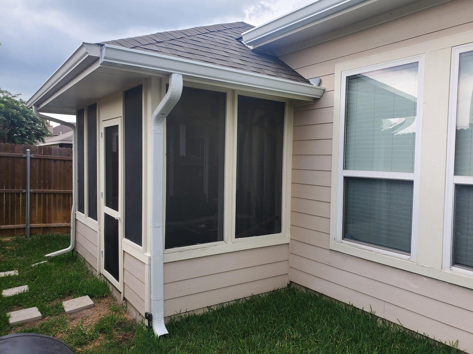 Gutter and downspout at a screened porch on a Texas home