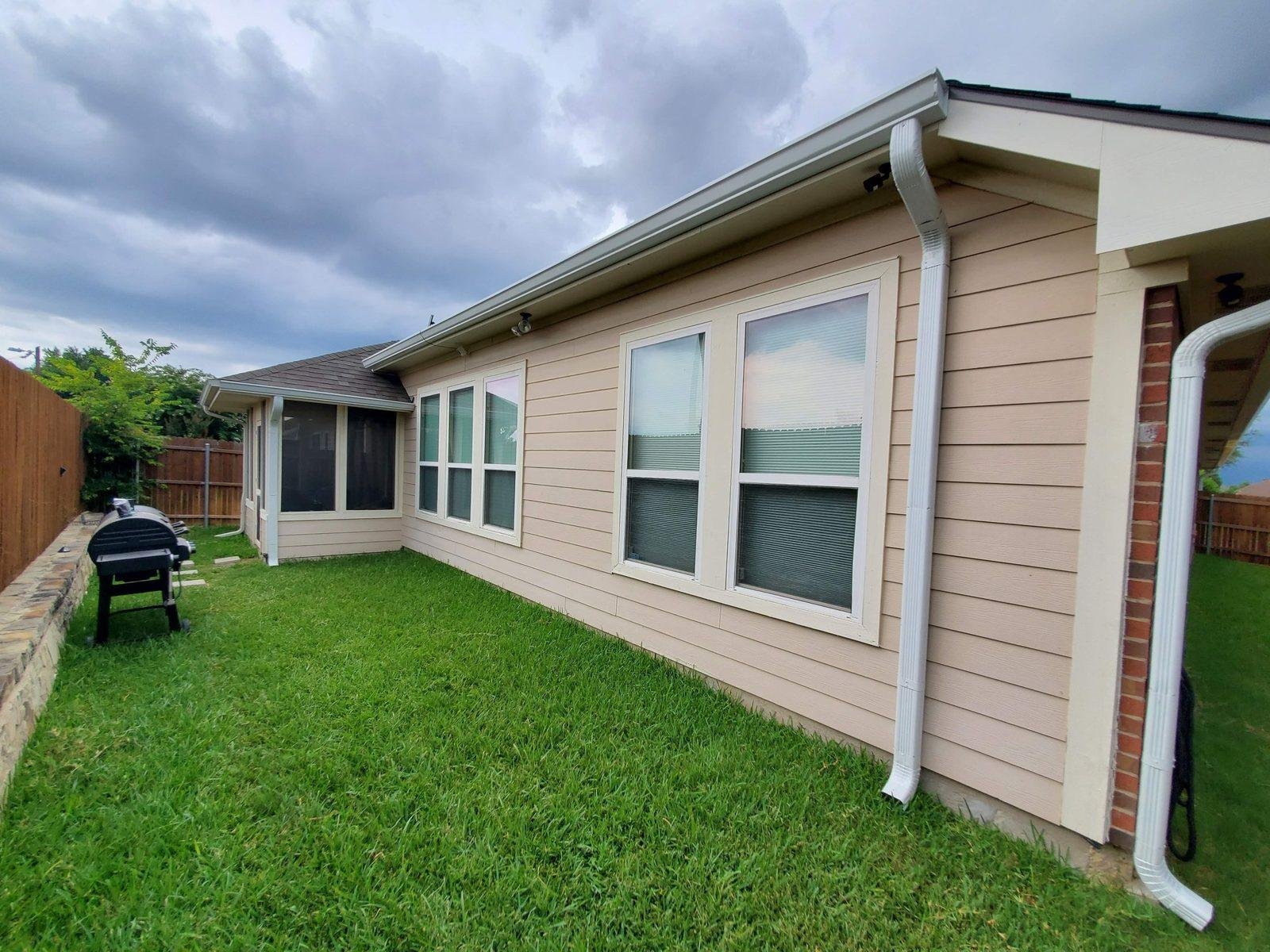 Seamless gutter run along the rear elevation of a Texas home
