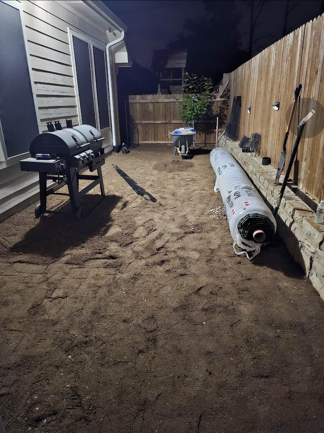 Graded and compacted base course ready for artificial turf in a Texas back yard